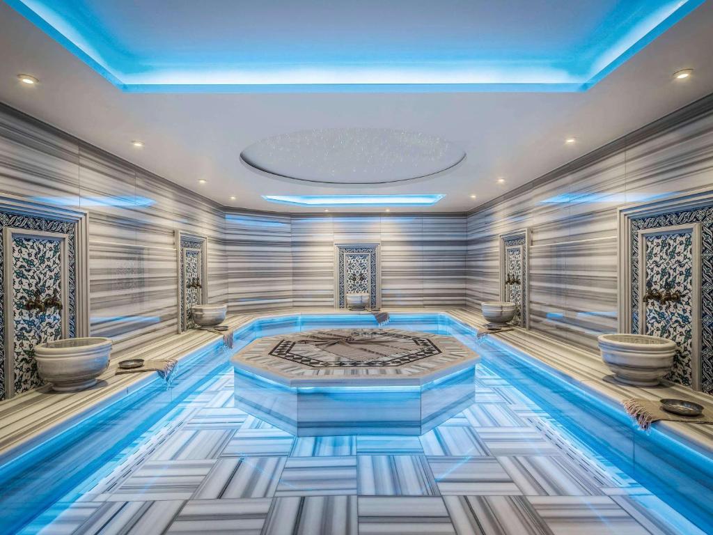 a room with a bed and a swimming pool at Novotel Istanbul Bosphorus Hotel in Istanbul