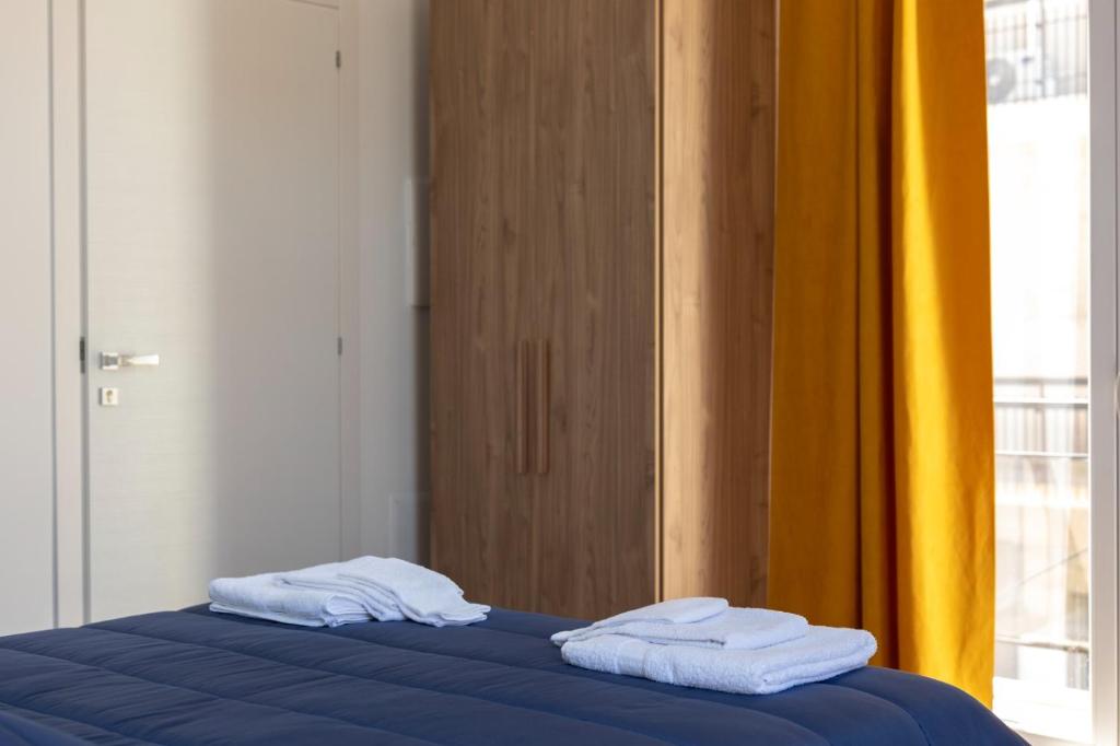 Postel nebo postele na pokoji v ubytování Palazzo Quattrone