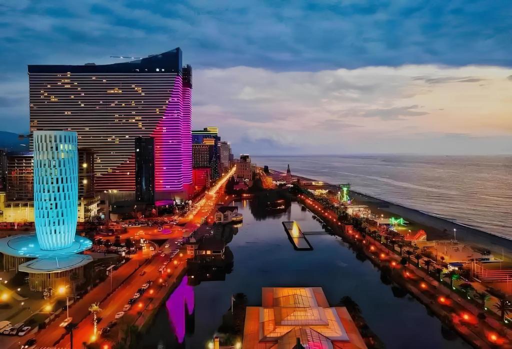 an aerial view of a city at night at Sea View Panoramic Suite Orbi City in Batumi