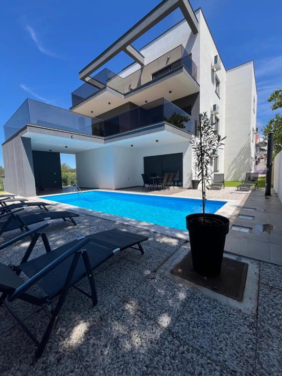 a house with a swimming pool in front of it at Residence Bella Vista in Bibinje