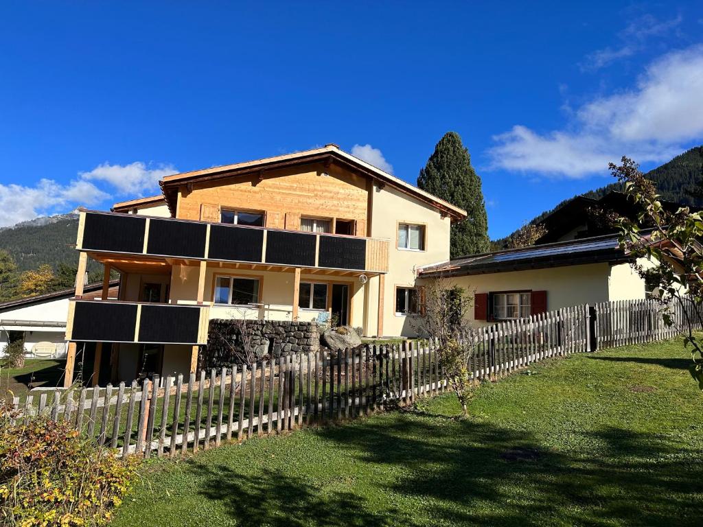 a house with solar panels on the side of it at Ferienwohnung Crameri in Klosters