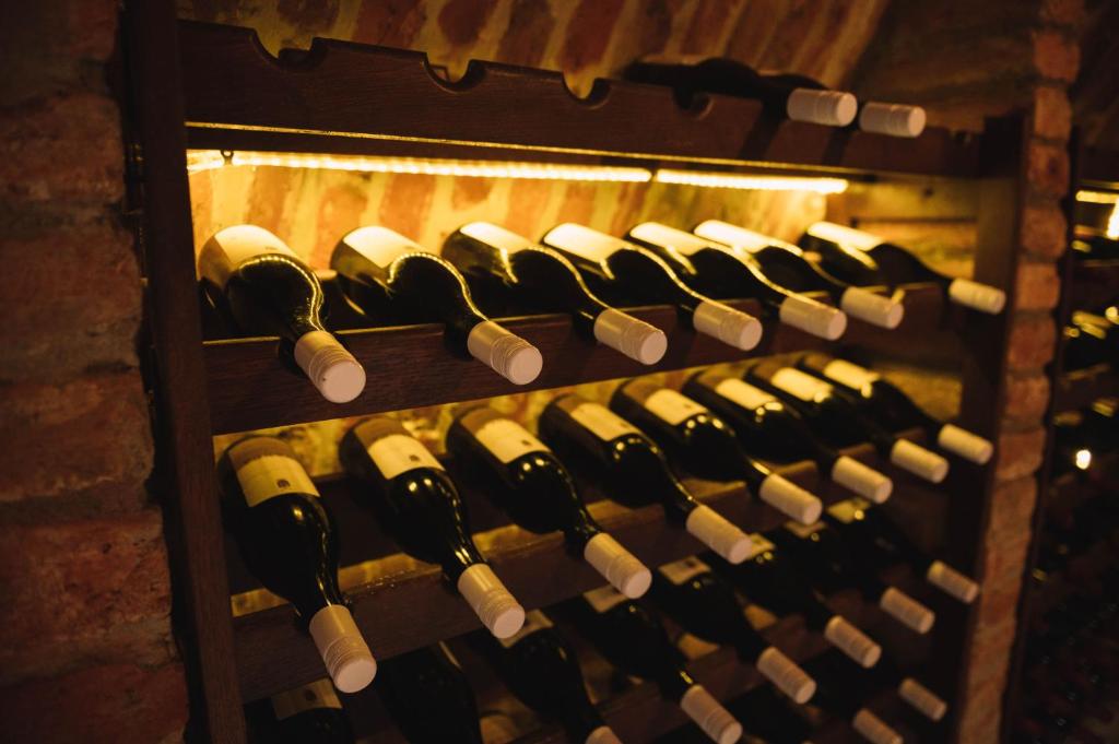a bunch of wine bottles in a wine cellar at Casa Vatra Sinteului - Cu sala de evenimente de capacitate mare - Se inchiriaza integral in Socet