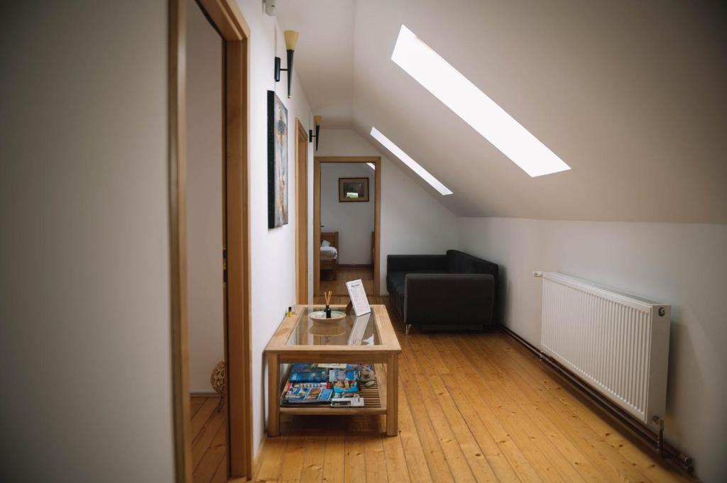 an attic room with a table and a chair at Casa Vatra Sinteului - Cu sala de evenimente de capacitate mare - Se inchiriaza integral in Socet