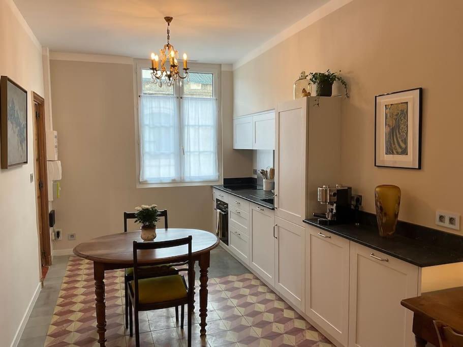 - une cuisine avec une table, une table et des chaises dans l'établissement Au cœur d'Avignon - Logement climatisé, à Avignon