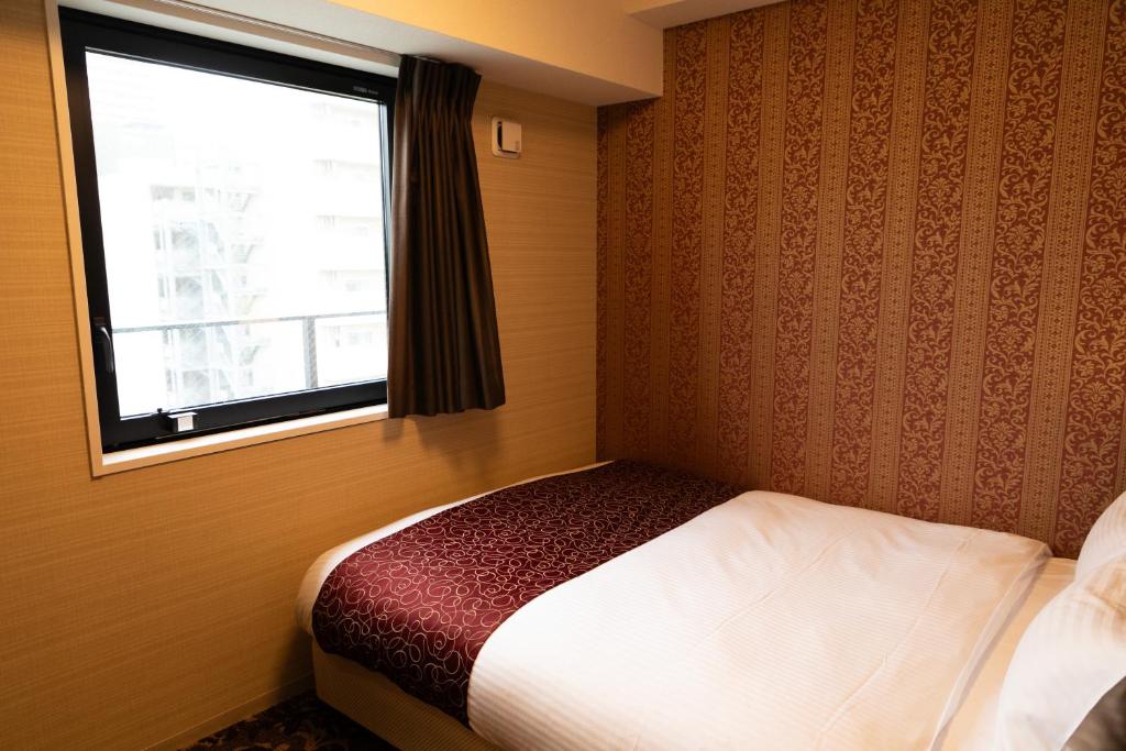 Postel nebo postele na pokoji v ubytování Hotel. Links Namba