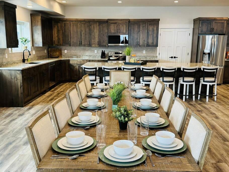 a large kitchen with a long table with chairs at Pickleball Paradise at Star Valley Ranch! in Thayne