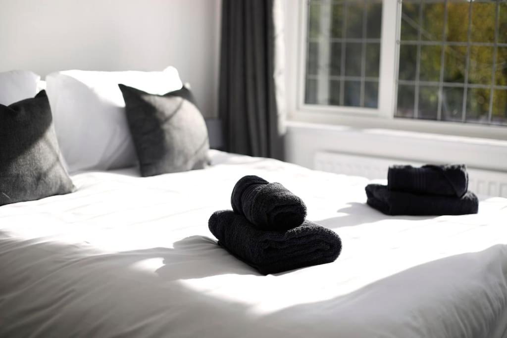 a bed with two towels on top of it at Beautiful Home in West Midlands 