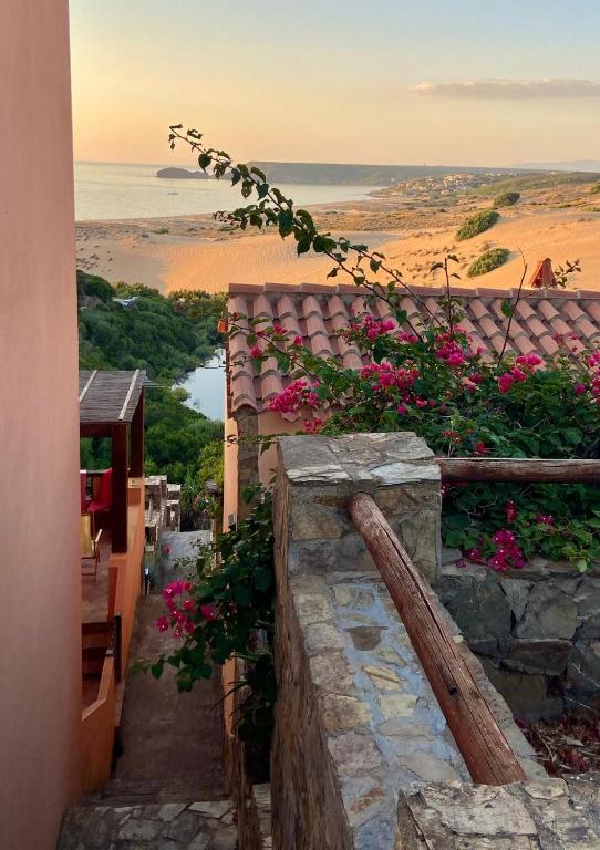 a stone stairway with pink flowers on a building at Casa Vacanza Suite Violet in Torre Dei Corsari