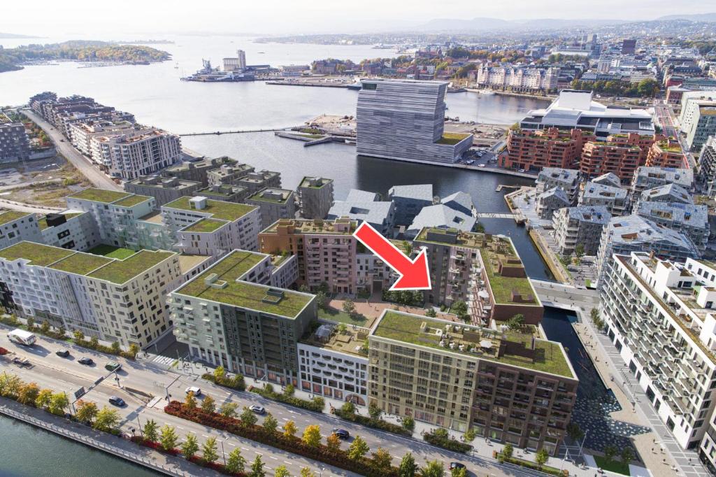 an aerial view of a city with a red arrow at Bjørvika - Beside the sea & in the city, near Oslo Centralstation in Oslo