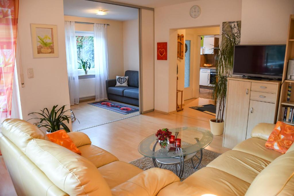 ein Wohnzimmer mit einem Sofa und einem Glastisch in der Unterkunft Ferienwohnung Gaby Lehmann in Hornberg