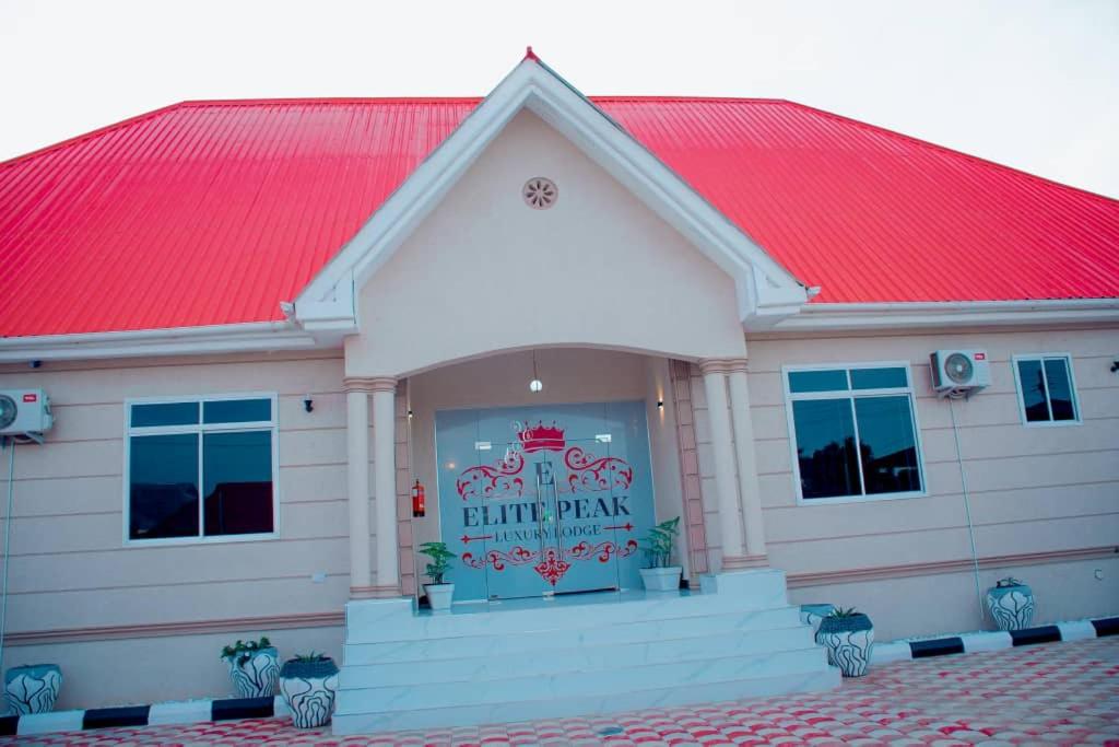 a white building with a red roof at ELITE PEAK LUXURY LODGE in Dodoma