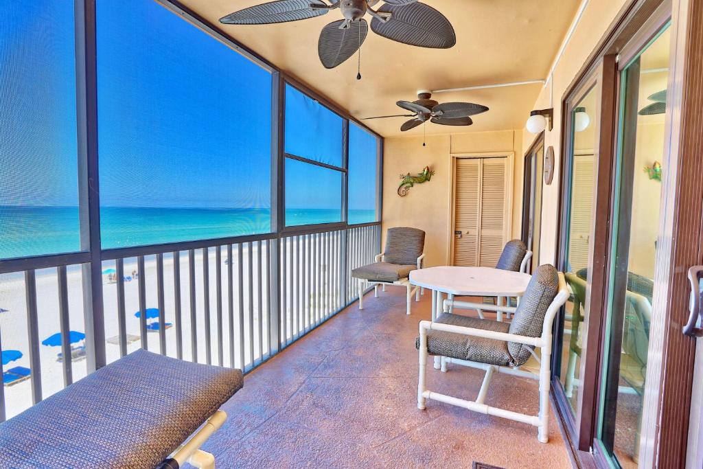a balcony with a table and chairs and the ocean at Villa Madeira 404 - Premier in St. Pete Beach
