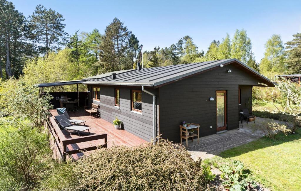 a small house with a deck and a patio at 2 Bedroom Lovely Home In Ebeltoft in Ebeltoft