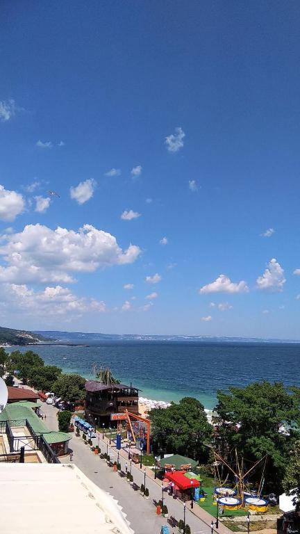 a view of a beach with the ocean in the background at Golden Sands Rentals Apartments in Golden Sands