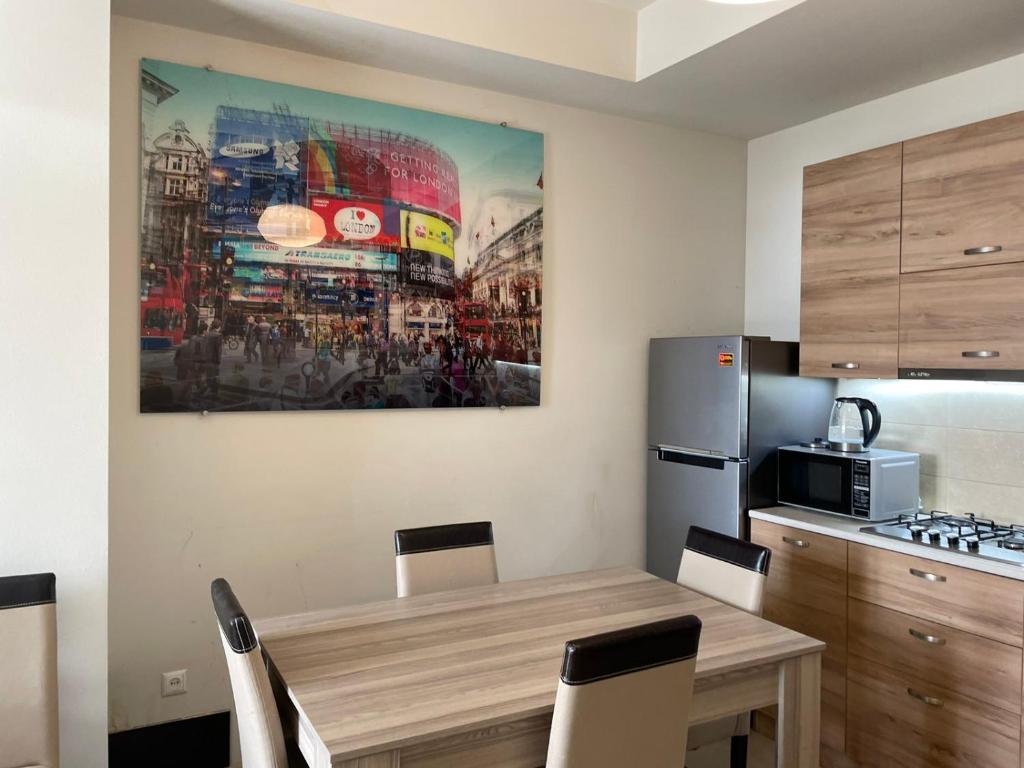 a kitchen with a table and a painting on the wall at Chavchavdze VAKE - 1BR Apartment in Tbilisi City