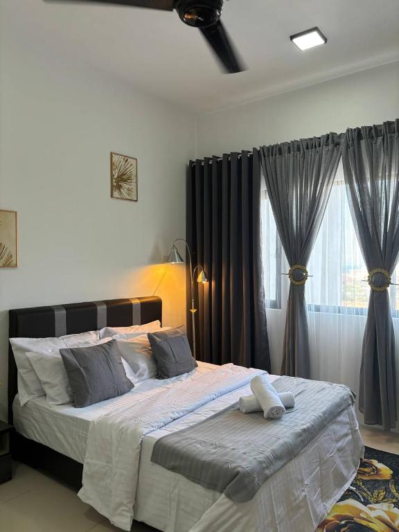 a bedroom with a large bed with grey curtains at Icon Residence Premium Condo in Kuala Terengganu