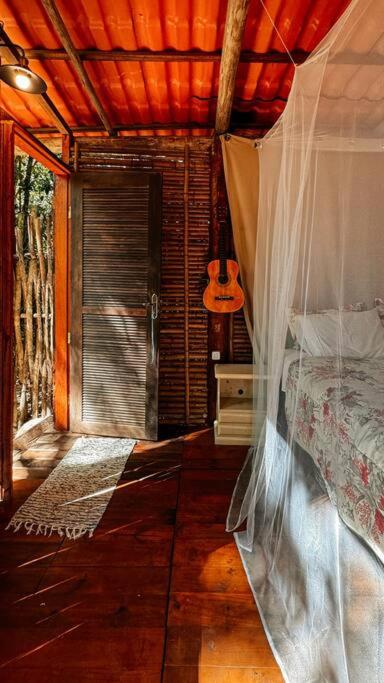a bedroom with a bed in a room with a window at Casa na Vila de Abraão in Abraão