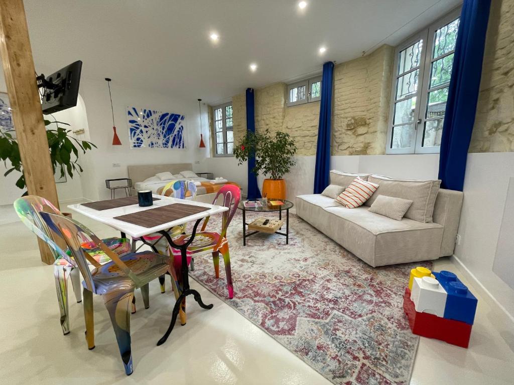 a living room with a table and chairs and a couch at Studio 11 Bis in Vichy