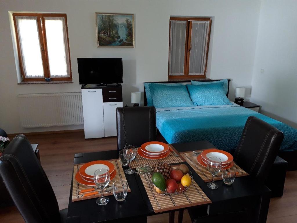 Habitación con cama y mesa con fruta. en Abgeschiedene Berghütte mit 6 Schlafzimmern, umgeben von einem Pinienwald, en Rudanovac