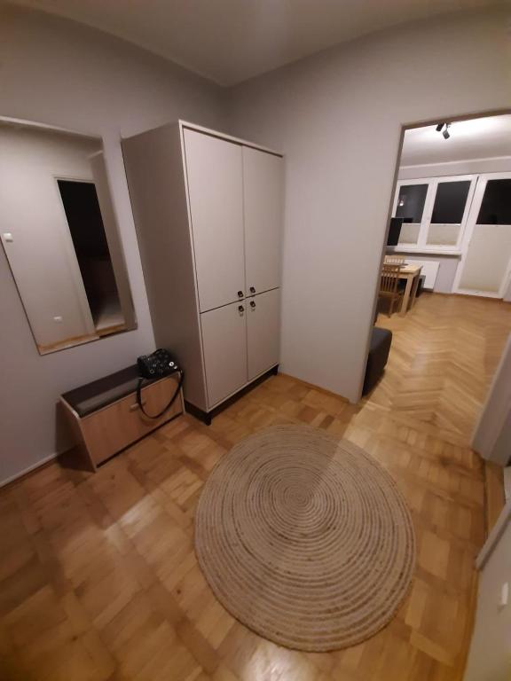an empty living room with a large rug on a wooden floor at Apartament Sopotkowo "WYJĄTKOWY" in Sopot