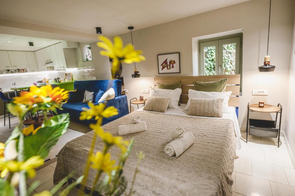a bedroom with a large bed and a kitchen at MASTER ROSE STUDIO in old town in Nafplio