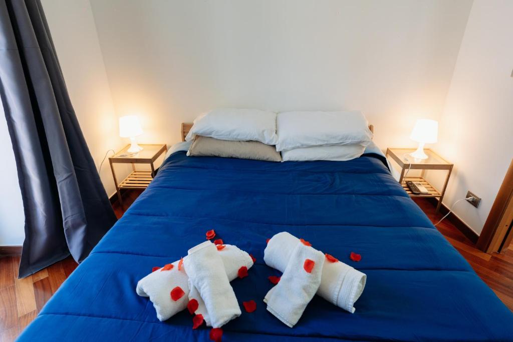 a bed with two towels with hearts on it at Palazzo Boemondo in Bari