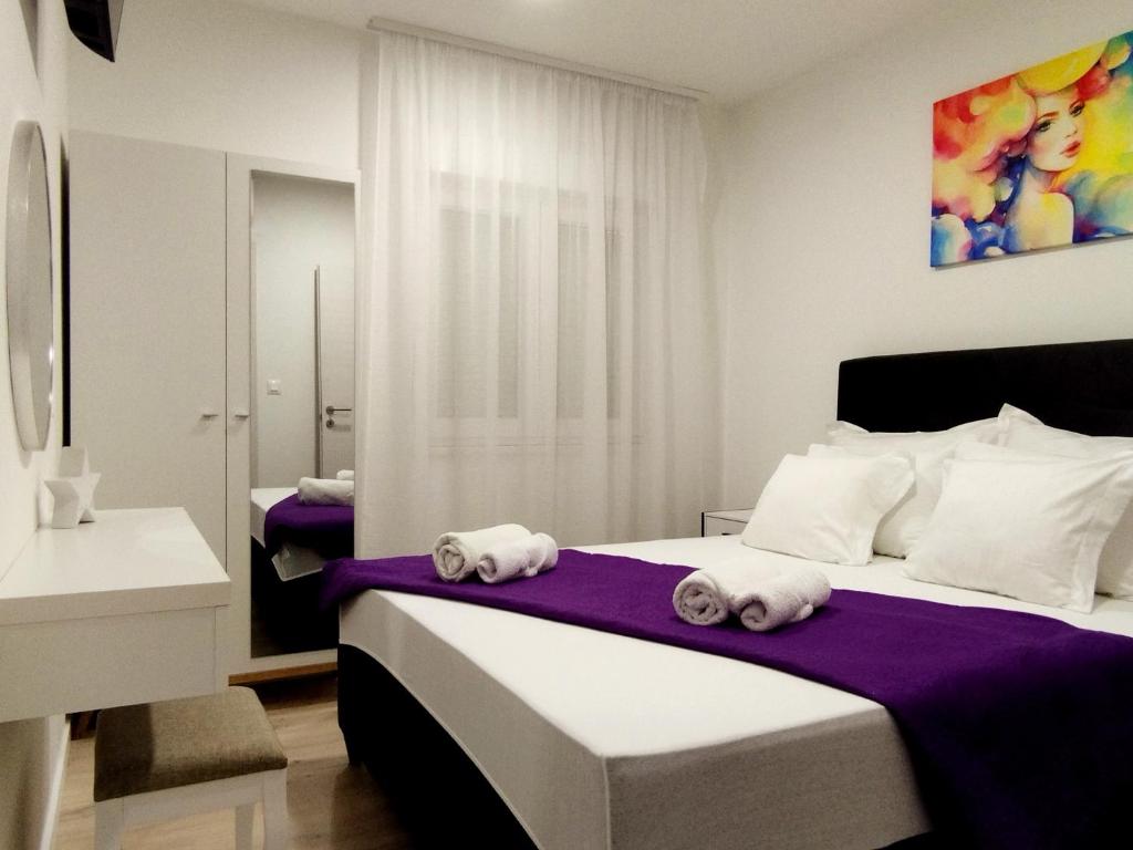 a bedroom with a bed with towels on it at Apartment Lantana Hvar in Hvar