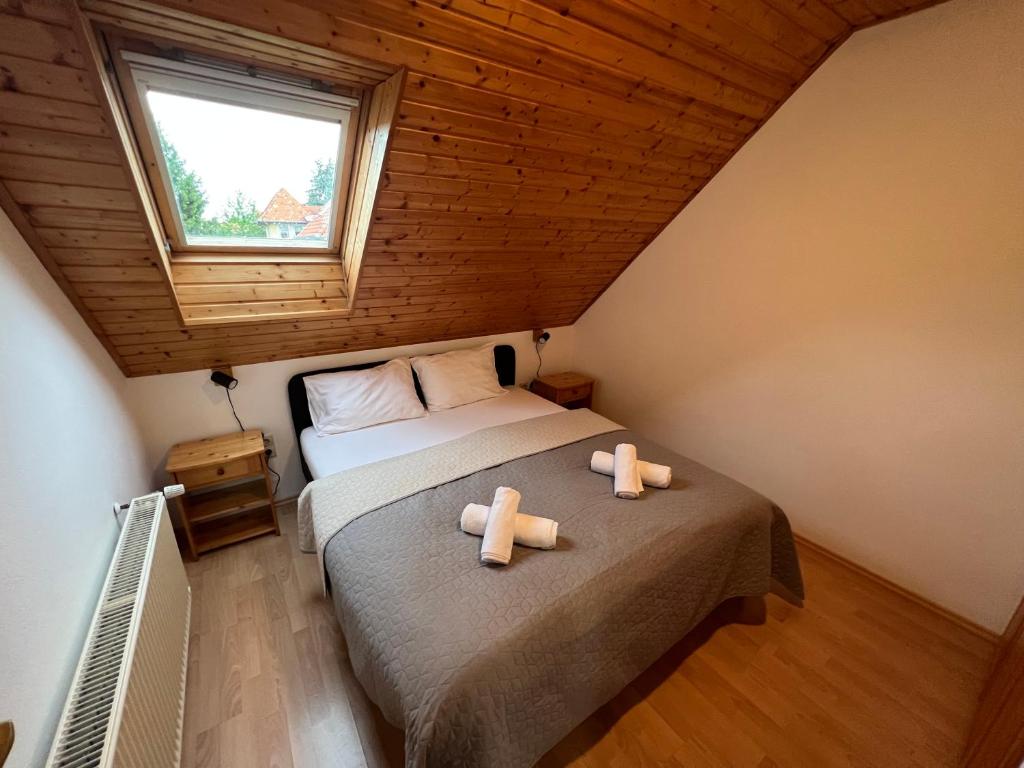 a bedroom with a bed with two towels on it at Lucky Villa in Hévíz