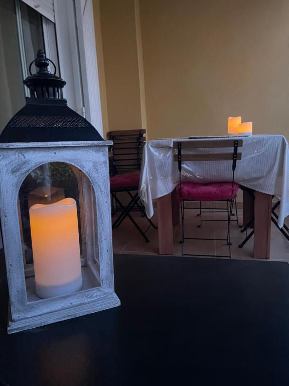 a candle in a lantern sitting on a table at Casa Amarela Guesthouse, Algorfa by Primavera GuestHouses in Algorfa