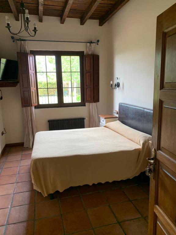 A bed or beds in a room at Posada El Jardin de Angela