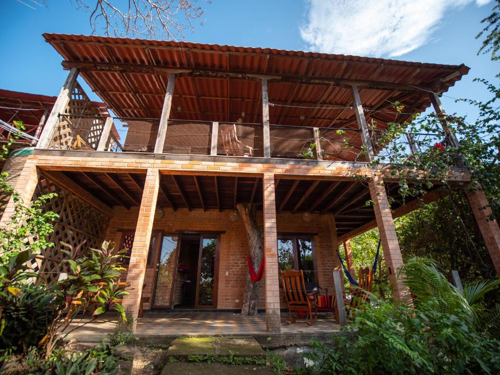 a house with a roof on top of it at 2 bedroom apartment in lush garden, 3 blocks from beach and center of San Juan in San Juan del Sur