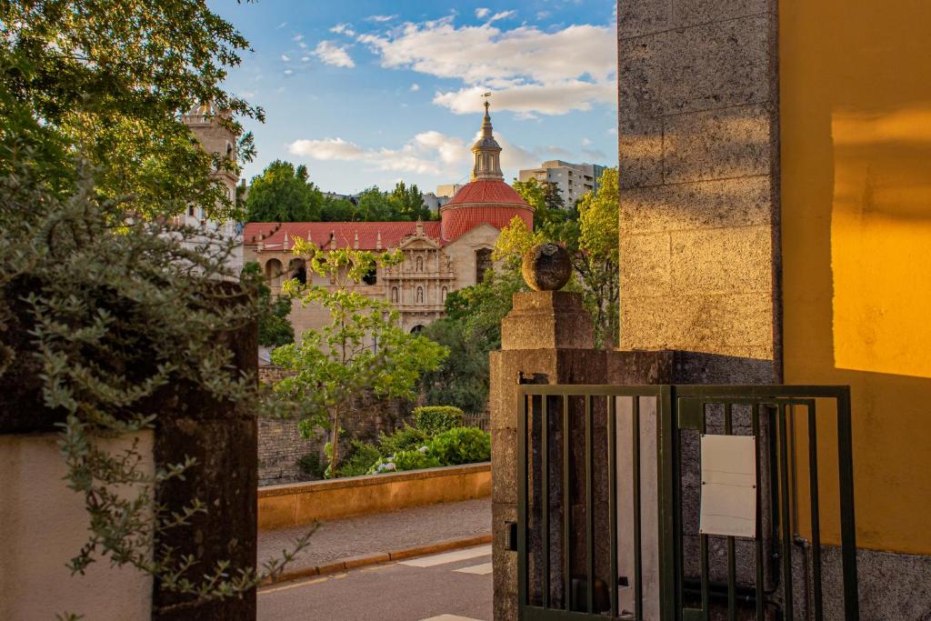 a gate with a view of a castle at Casa do Ribeirinho in Amarante