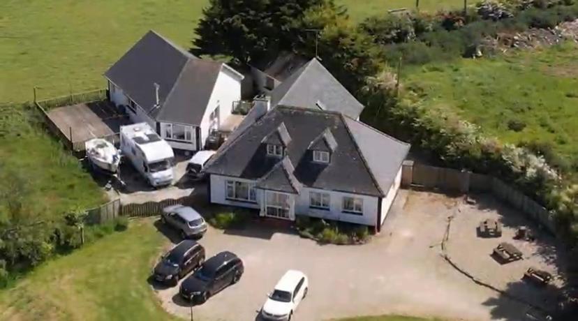 an aerial view of a house with cars parked in a parking lot at Padua Guest Accommodation Rosslare in Rosslare