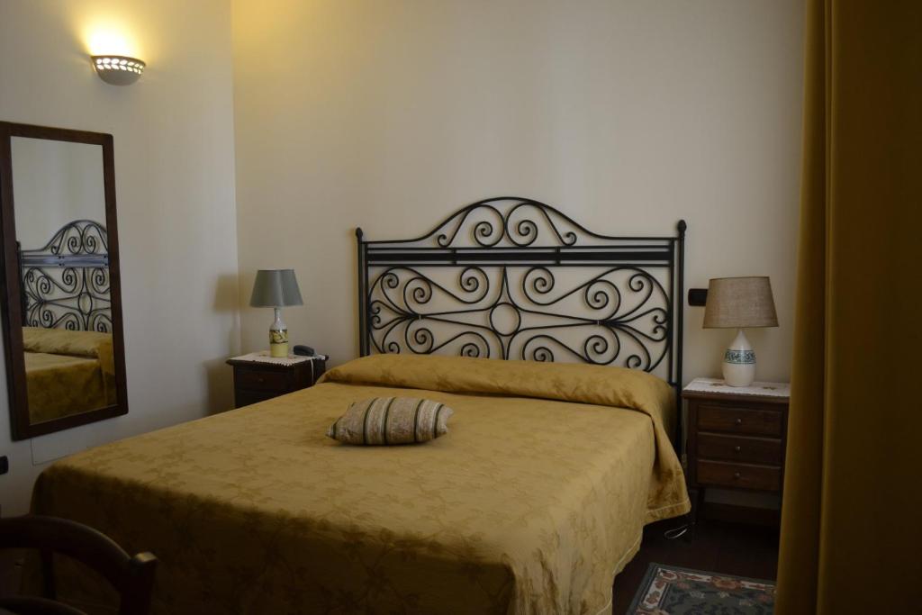 Кровать или кровати в номере Masseria Gattamora