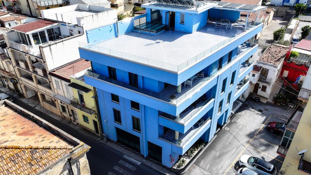 una vista aérea de un edificio azul en una calle de la ciudad en After Sun, en Patti