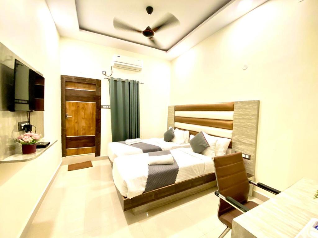 a bedroom with a large bed in a room at Hotel Sky International- Airport Zone Hyderabad in Shamshabad