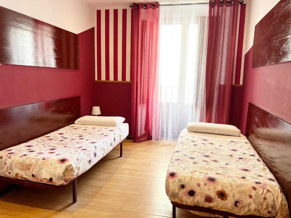 A bed or beds in a room at Hostal Abaaly
