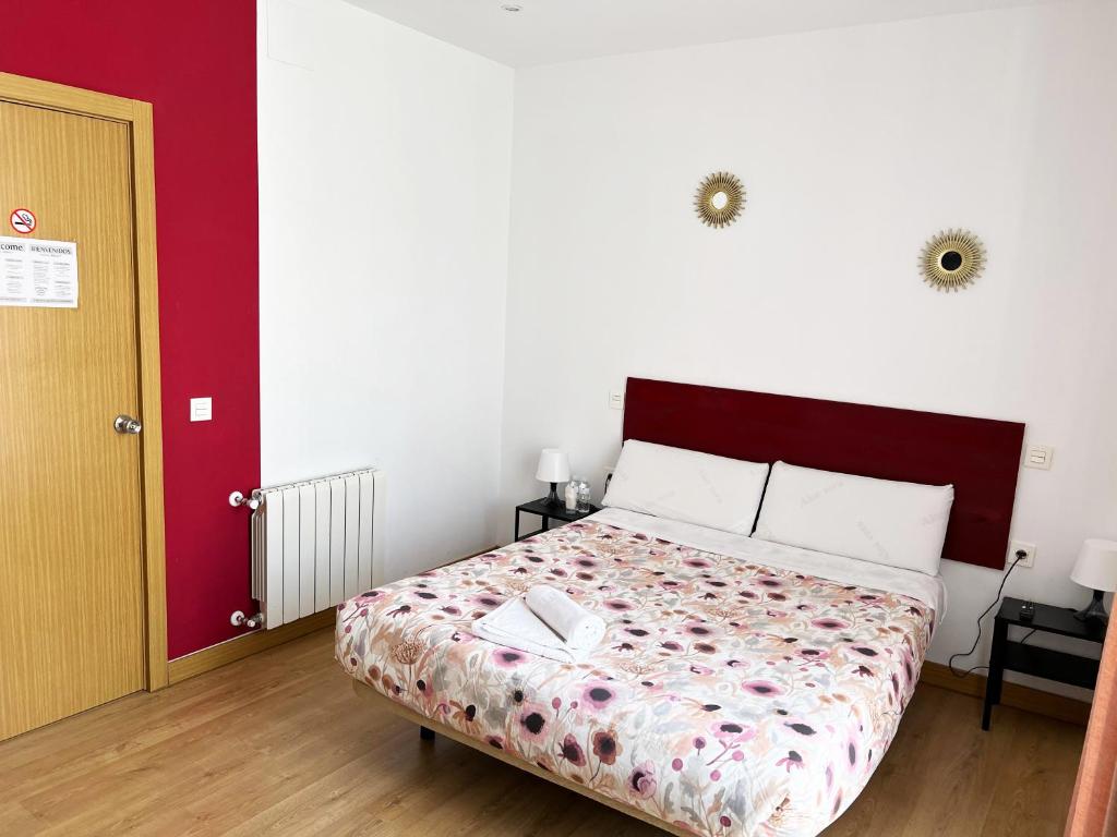 A bed or beds in a room at Hostal Abaaly