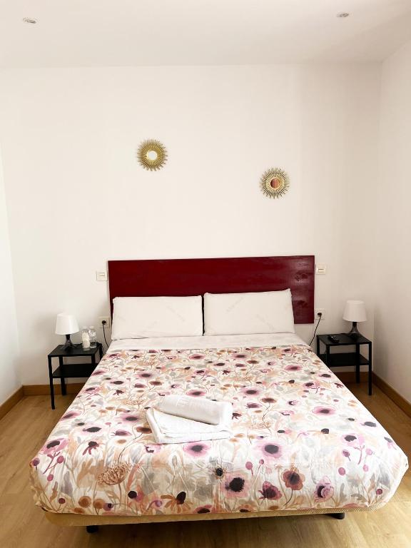 A bed or beds in a room at Hostal Abaaly