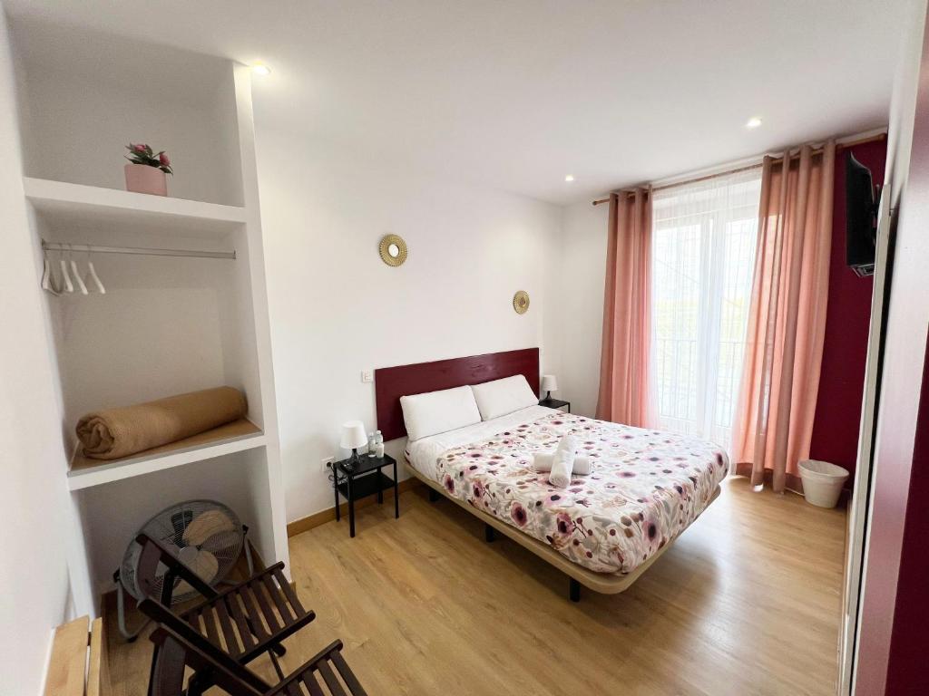 A bed or beds in a room at Hostal Abaaly
