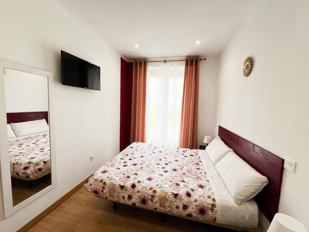 A bed or beds in a room at Hostal Abaaly