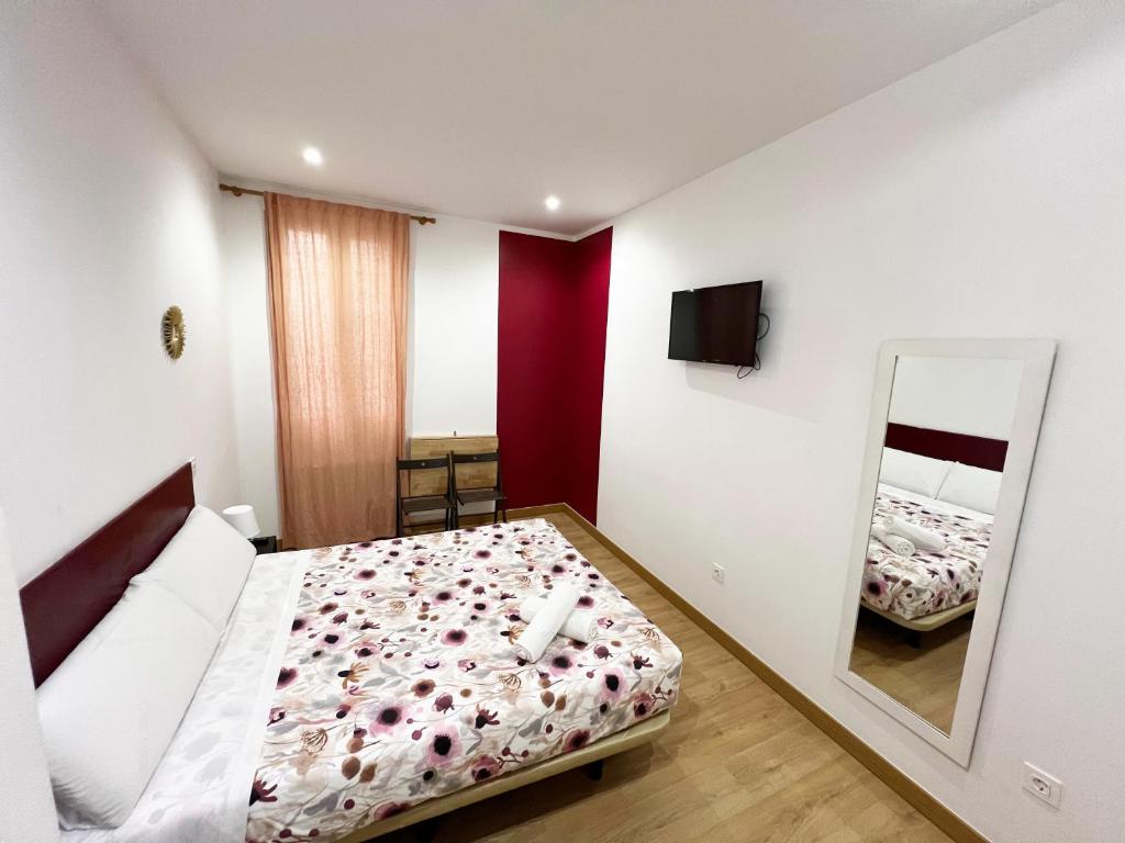 A bed or beds in a room at Hostal Abaaly