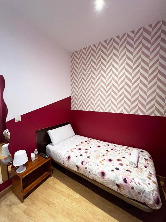 A bed or beds in a room at Hostal Abaaly