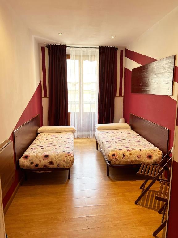 A bed or beds in a room at Hostal Abaaly