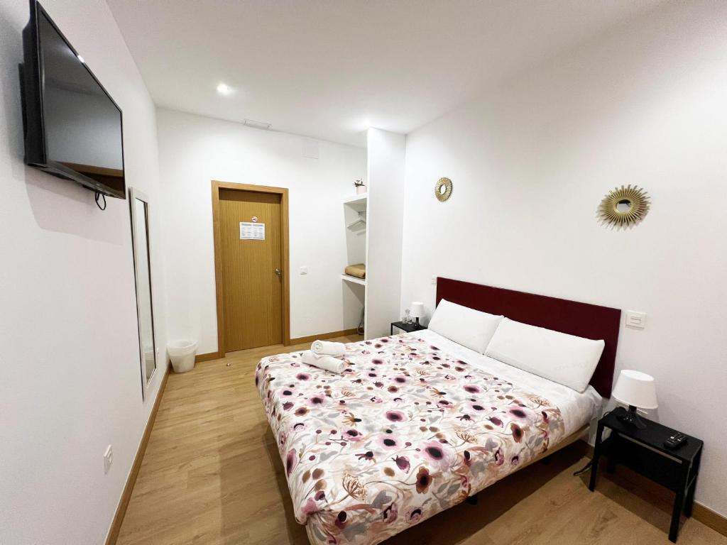 A bed or beds in a room at Hostal Abaaly