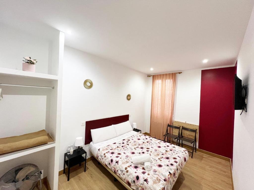A bed or beds in a room at Hostal Abaaly