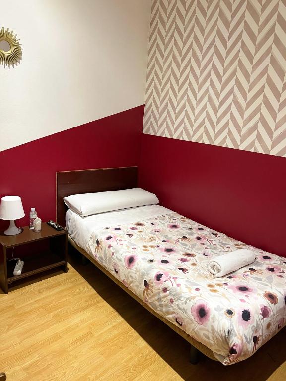 A bed or beds in a room at Hostal Abaaly