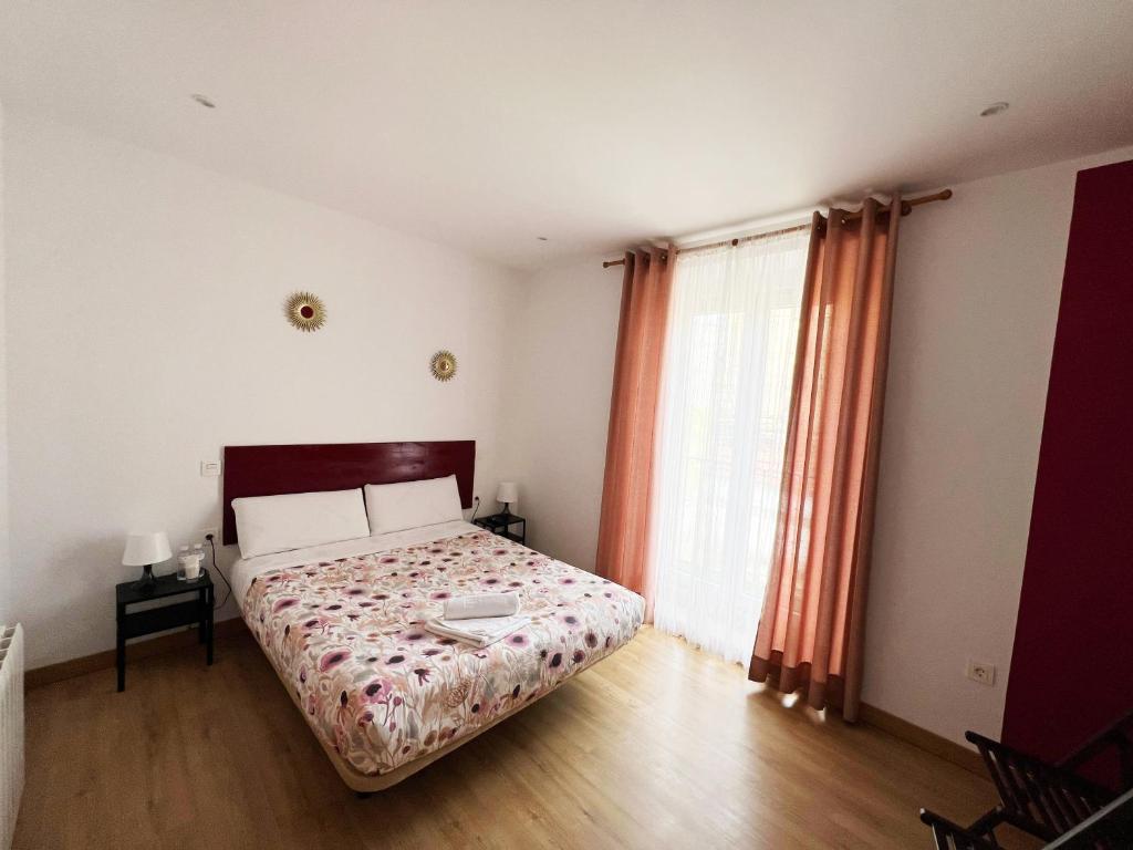 A bed or beds in a room at Hostal Abaaly