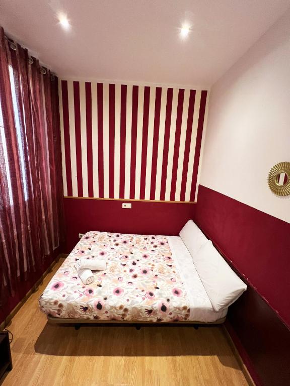 A bed or beds in a room at Hostal Abaaly