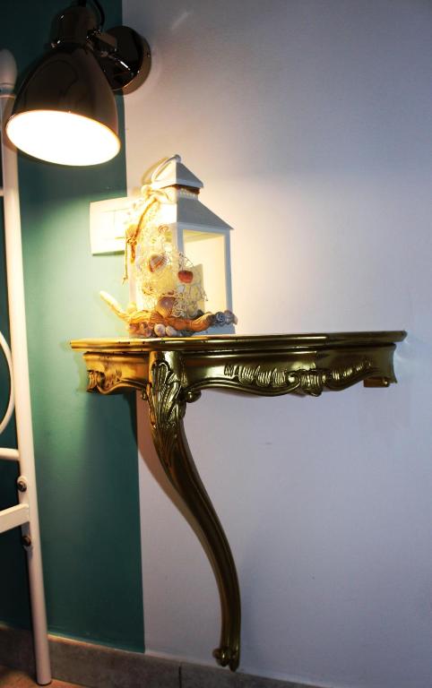 a table with a lamp on top of it at B&B Casa del Faro SanVallero Adults Only in Portopalo